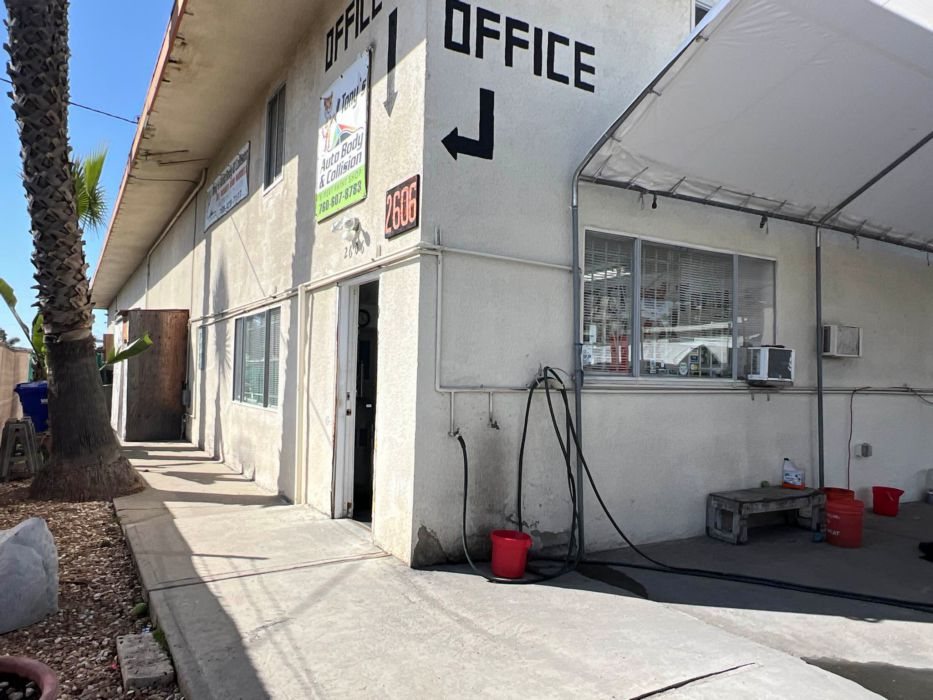 Tony's Auto Body shop exterior with OFFICE sign on Industry St